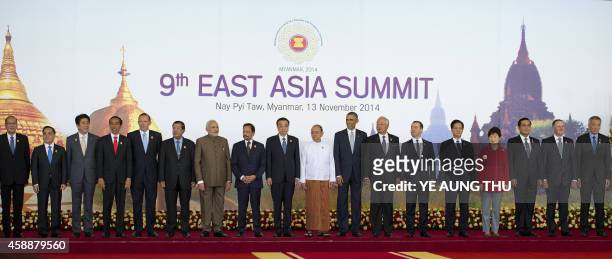 Myanmar President Thein Sein stands next to US President Barack Obama and China's Prime Minister Li Keqiang and other leaders as they pose for a...