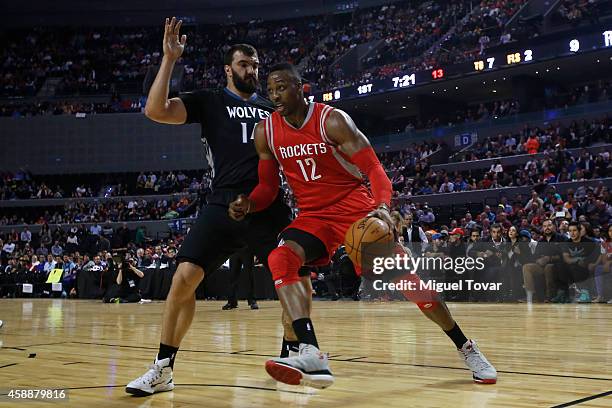 Dwight Howard of Houston Rockets drives to the basket against Nikola Pekovic of Minnesota Timberwolves during a match between Minnesota Timberwolves...