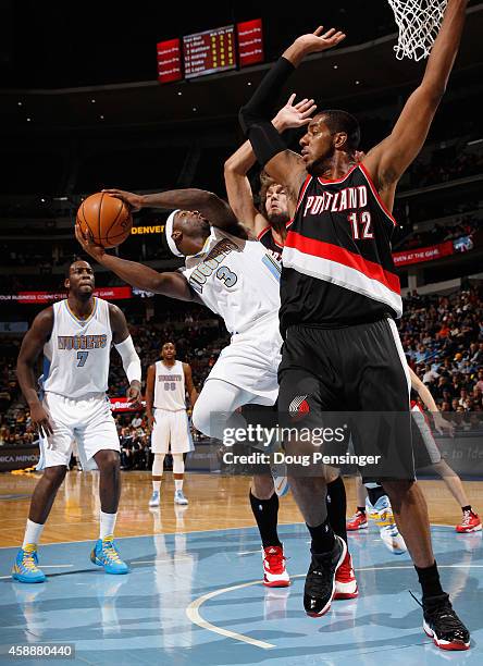 Ty Lawson of the Denver Nuggets tries to get off a shot against LaMarcus Aldridge of the Portland Trail Blazers at Pepsi Center on November 12, 2014...