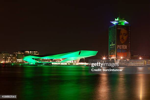 dutch film institute eye goes green on saint patrick's day - amsterdam light festival stock pictures, royalty-free photos & images