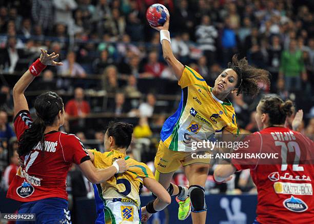 Brazil's Ana Rodrigues throws the ball as Serbia's Sanja Damnjanovic tries to block it during the 2013 Women's Handball World Championship final...