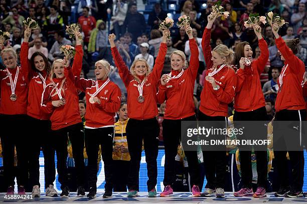 Denmark's players poses with their bronze medals after defeating Poland in their 2013 Women's Handball World Championship final match for third place...
