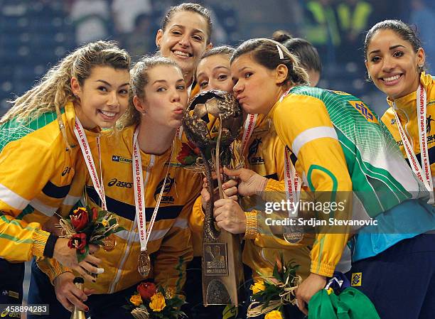 Brazil players kiss the tournament trophy after beating Serbia in their World Women's Handball Championship 2013 Final match at Kombank Arena Hall on...
