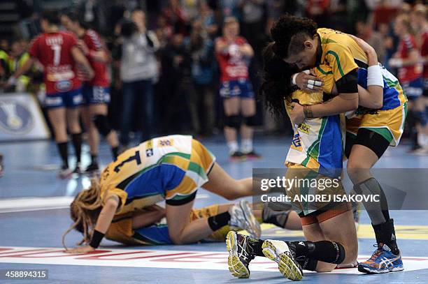 Brazil's players react after winning the 2013 Women's Handball World Championship final match between Brazil and Serbia at the Kombank Arena in...