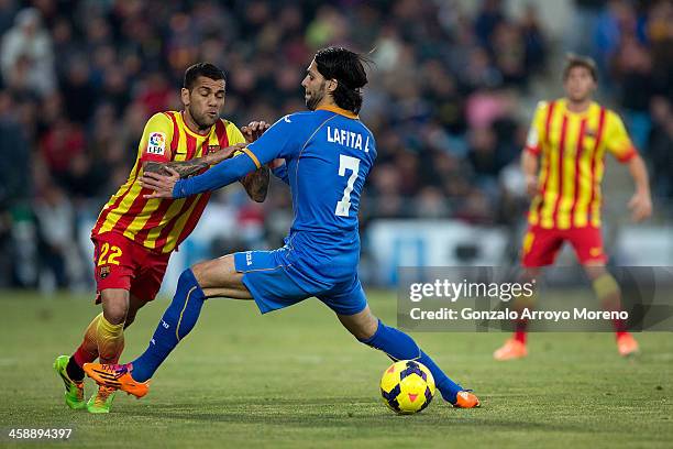 Dani Alves of FC Barcelona is stopped by Angel Lafita of Getafe CF during the La Liga match between Getafe CF and FC Barcelona at Coliseum Alfonso...