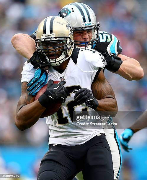 Luke Kuechly of the Carolina Panthers tackles Marques Colston of the New Orleans Saints during their game at Bank of America Stadium on December 22,...