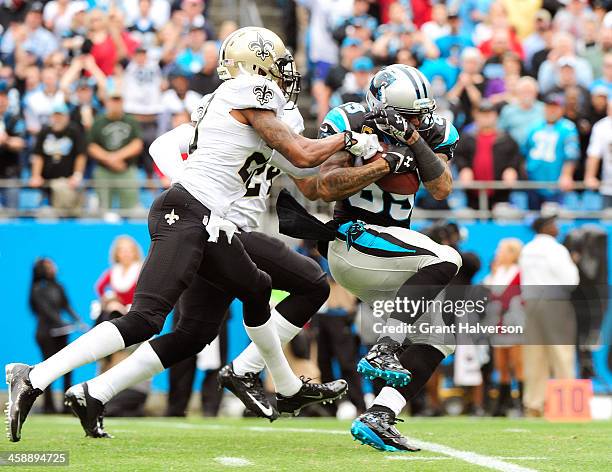 Steve Smith of the Carolina Panthers makes a catch as Corey White and Keenan Lewis of the New Orleans Saints defend during their game at Bank of...