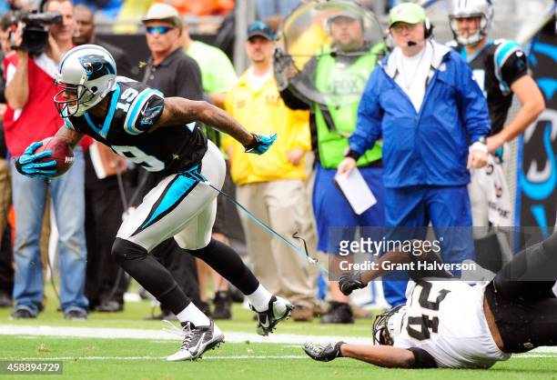 Ted Ginn of the Carolina Panthers breaks away from Isa Abdul-Quddus of the New Orleans Saints during their game at Bank of America Stadium on...