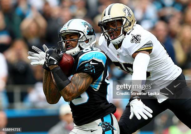 Steve Smith of the Carolina Panthers makes a catch as Keenan Lewis of the New Orleans Saints tries to knock the ball loose during their game at Bank...