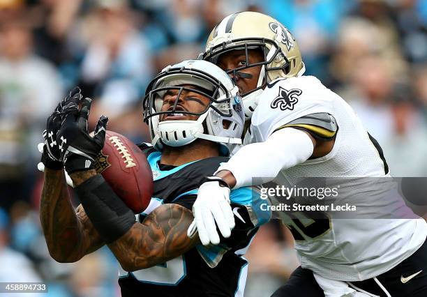 Steve Smith of the Carolina Panthers makes a catch as Keenan Lewis of the New Orleans Saints tries to knock the ball loose during their game at Bank...