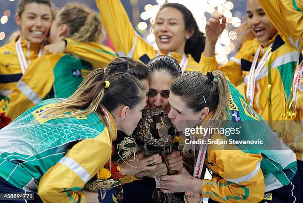 Players of Brazil kiss the tournament trophy during award ceremony for the World Women's Handball Championship 2013 at Kombank Arena Hall on December...