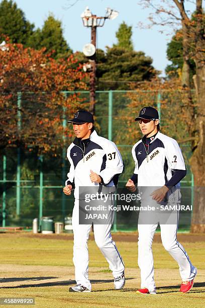 Catcher Motohiro Shima and Catcher Hikaru Ito of Samurai Japan in action during a training session at Jing Gaien Field on November 13, 2014 in Tokyo,...