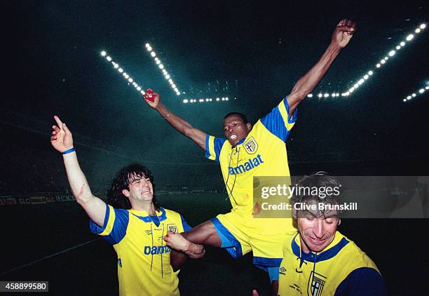 Parma striker Faustino Asprilla is held aloft by team mates Fernando Coulo and Massimo Crippa after the second leg of the 1995 UEFA Cup Final between...