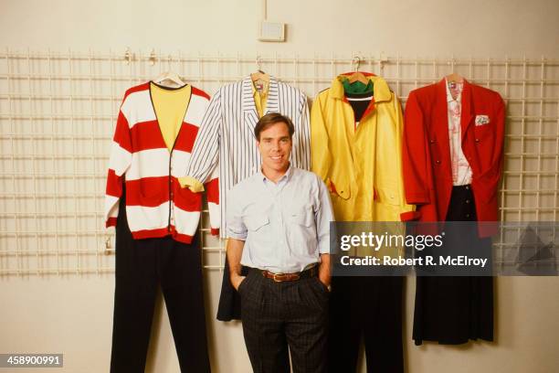 Fashion designer Tommy Hilfiger poses with his designs in his studio, New York, September 10, 1987.