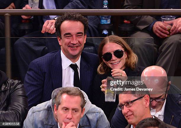 Olivier Sarkozy and Mary-Kate Olsen attend the Orlando Magic vs New York Knicks game at Madison Square Garden on November 12, 2014 in New York City.