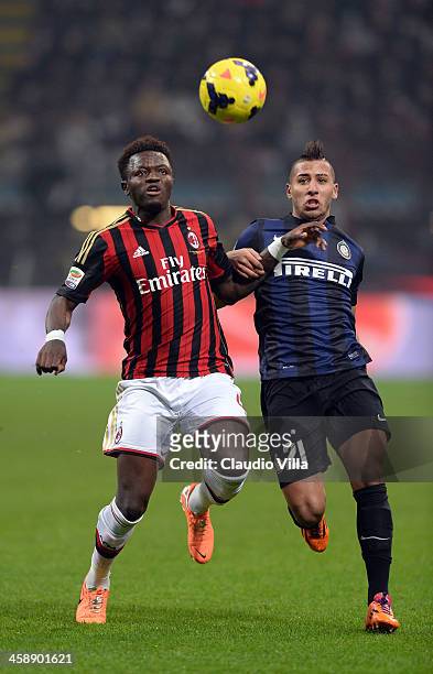 Saphir Taider of FC Inter Milan and Sulley Muntari of AC Milan compete for the ball during the Serie A match between FC Internazionale Milano and AC...