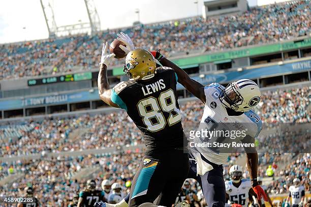 Marcedes Lewis of the Jacksonville Jaguars catches a touchdown pass over Bernard Pollard of the Tennessee Titans during a game at EverBank Field on...
