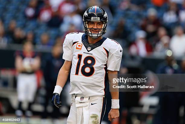 Peyton Manning of the Denver Broncos celebrates after throwing his fourth touchdown during the game against the Houston Texans at Reliant Stadium on...