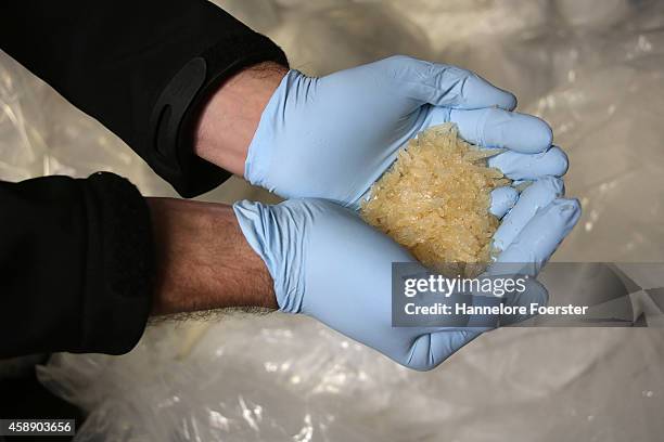 Members of the Bundeskriminalamt German law enforcement agency , the Federal Criminal Office, display portions of 2.9 tonnes of recently-confiscated...