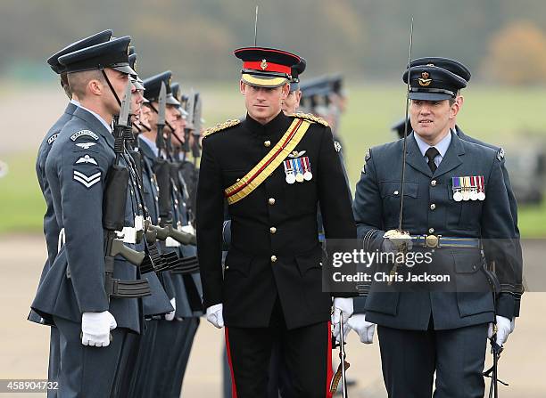 Prince Harry, Honorary Air Commandant, inspects a guard of honour as he visits RAF Honington on November 13, 2014 in Bury St Edmunds, England. The...