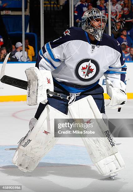 Ondrej Pavelec of the Winnipeg Jets skates against the New York Islanders at Nassau Veterans Memorial Coliseum on October 28, 2014 in Uniondale, New...