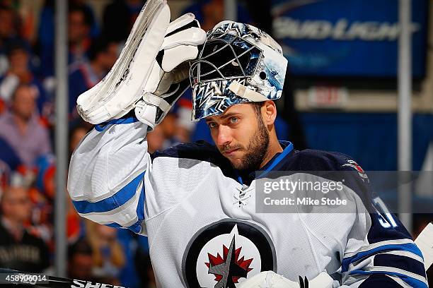 Ondrej Pavelec of the Winnipeg Jets skates against the New York Islanders at Nassau Veterans Memorial Coliseum on October 28, 2014 in Uniondale, New...