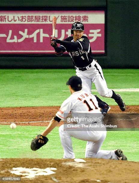 Takashi Toritani of the Hanshin Tigers hits a RBI single in the top of 5th inning during the Game four of the Central League Climax Series between...