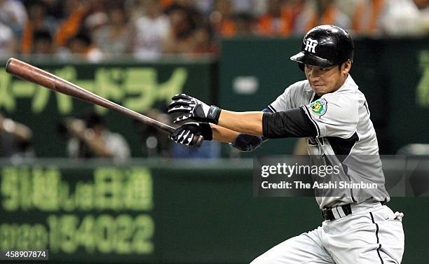 Takashi Toritani of the Hanshin Tigers hits a two-run single in the top of 2nd inning during the Central League game between Hanshin Tigers and...