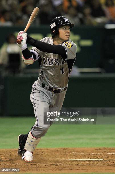 Takashi Toritani of the Hanshin Tigers hits a tw-run homer in the top of 3rd inning during the Central League game between Hanshin Tigers and Yomiuri...