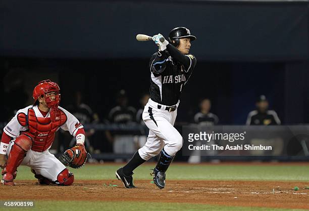 Takashi Toritani of the Hanshin Tigers hits a two-run homer in the top of 8th inning during the Central League game between Hanshin Tigers and...