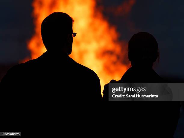 A Couple Looking At A Midsummer Bonfire High-Res Stock Photo