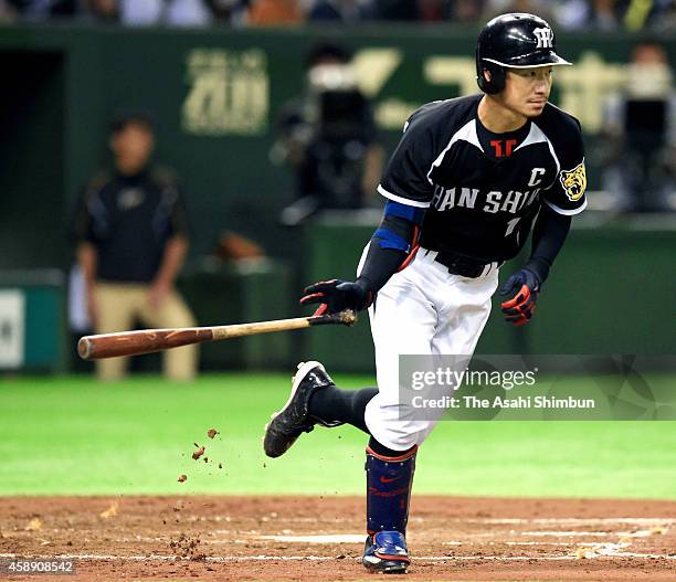 Taksahi Toritani of the Hanshin Tigers hits a two-run single in the top of 3rd inning during the Game four of the Central League Climax Series...