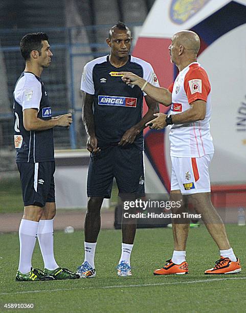 Atletico de Kolkata players Luis Garcia and Fiku having discussion with coach Antonio Habas during practice ahead of their match against visiting...