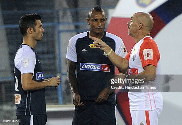 Atletico de Kolkata players Luis Garcia and Fiku having discussion with coach Antonio Habas during practice ahead of their match against visiting...