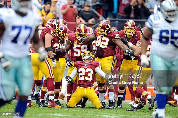 DeAngelo Hall of the Washington Redskins celebrates with teammates after making an interception in the third quarter against the Dallas Cowboys at...