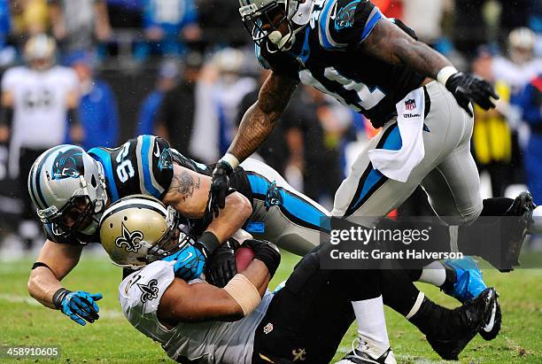 Chase Blackburn and Captain Munnerlyn of the Carolina Panthers tackles Mark Ingram of the New Orleans Saints for a loss during their game at Bank of...