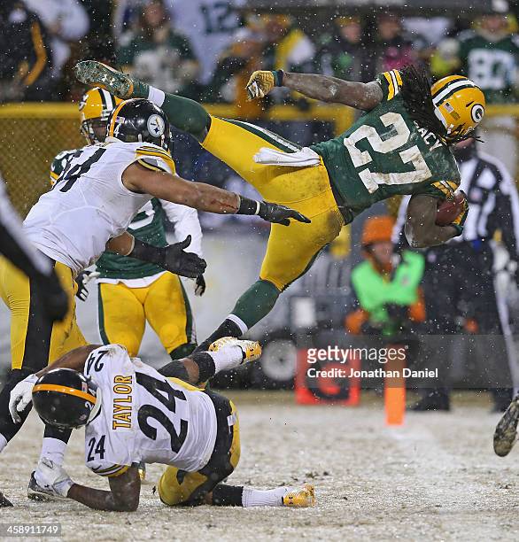Eddie Lacy of the Green Bay Packers dives into the end zone for a touchdown over Chris Carter and Ike Taylor of the Pittsburgh Steelers at Lambeau...