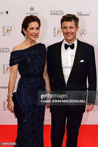 Frederik, Crown Prince of Denmark, and his wife Crown Princess Mary of Denmark, pose as they arrive for the Bambi awards on November 13, 2014 in...