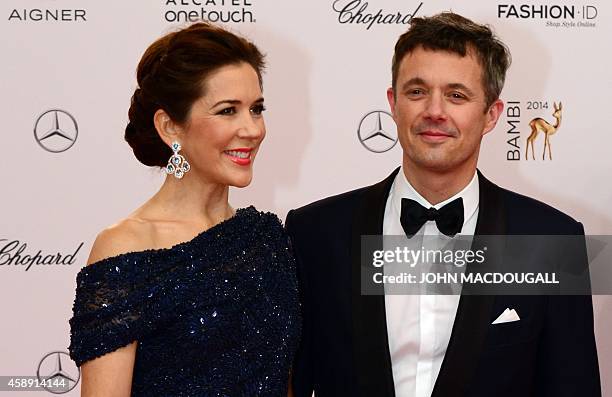 Frederik, Crown Prince of Denmark, and his wife Crown Princess Mary of Denmark, pose as they arrive for the Bambi awards on November 13, 2014 in...