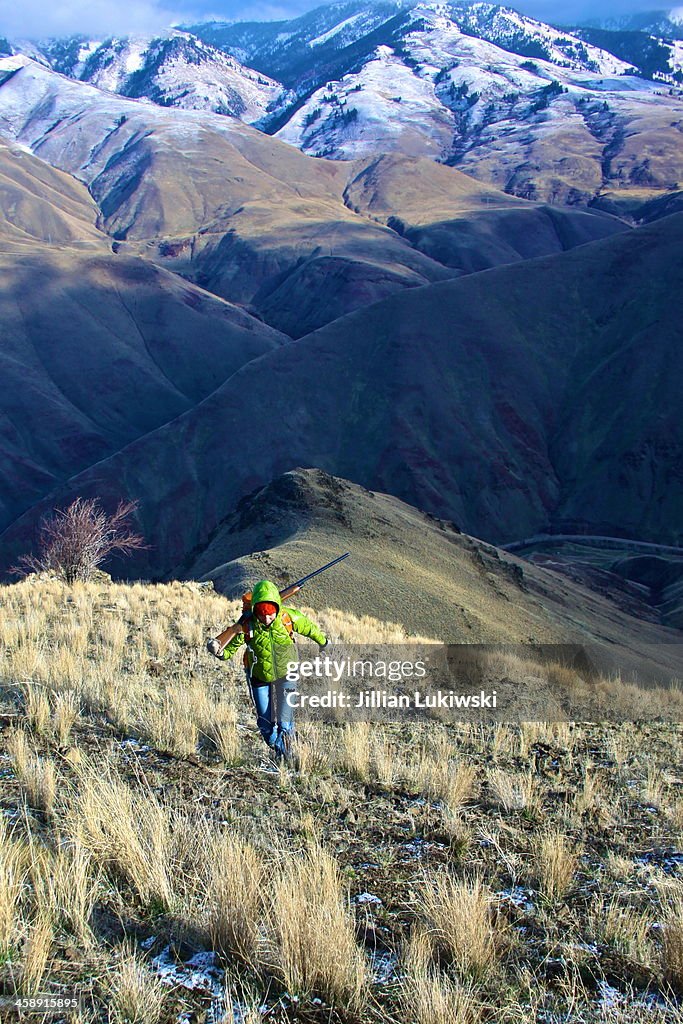 Hunter Climbing Steep Hillside