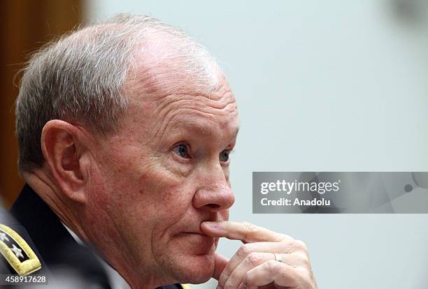 Chairman of the US Joint Chiefs of Staff General Martin Dempsey testifies beside US Secretary of Defense Chuck Hagel , during the House Armed...