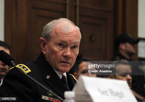 Chairman of the US Joint Chiefs of Staff General Martin Dempsey testifies beside US Secretary of Defense Chuck Hagel , during the House Armed...