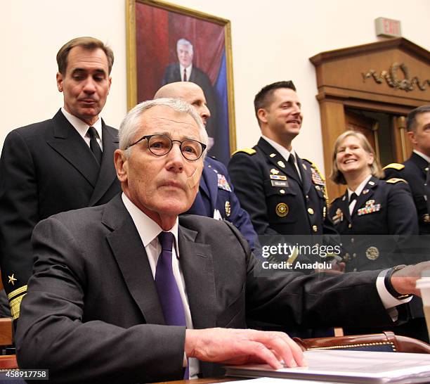 Secretary of Defense Chuck Hagel testifies beside Chairman of the US Joint Chiefs of Staff General Martin Dempsey , during the House Armed Services...