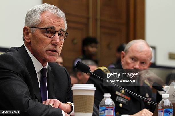 Secretary of Defense Chuck Hagel testifies beside Chairman of the US Joint Chiefs of Staff General Martin Dempsey , during the House Armed Services...