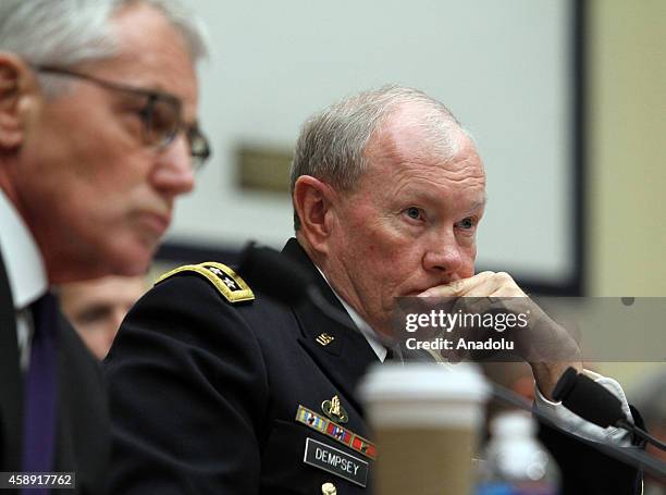 Secretary of Defense Chuck Hagel testifies beside Chairman of the US Joint Chiefs of Staff General Martin Dempsey , during the House Armed Services...