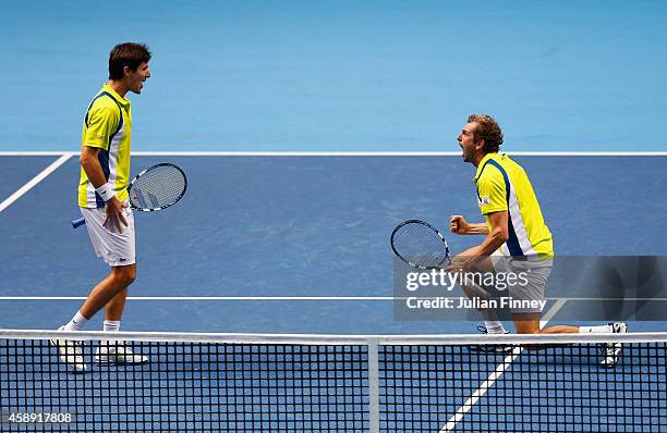 Edouard Roger-Vasselin of France and Julien Benneteau of France celebrate match point in the round robin doubles match against Ivan Dodig of Croatia...