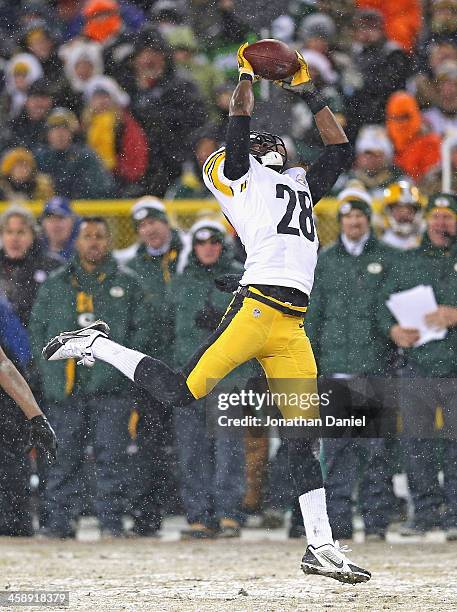 Cortez Allen of the Pittsburgh Steelers intercepts a pass for a touchdown against the Green Bay Packers at Lambeau Field on December 22, 2013 in...