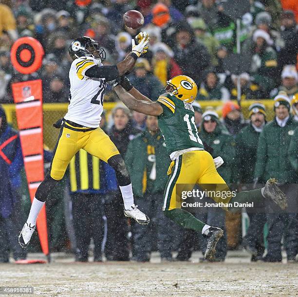 Cortez Allen of the Pittsburgh Steelers intercepts a pass for a touchdown over Jarrett Boykin of the Green Bay Packers at Lambeau Field on December...