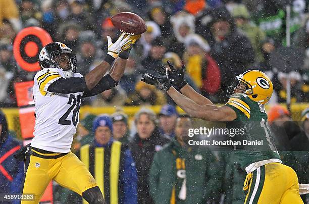 Cortez Allen of the Pittsburgh Steelers intercepts a pass for a touchdown over Jarrett Boykin of the Green Bay Packers at Lambeau Field on December...