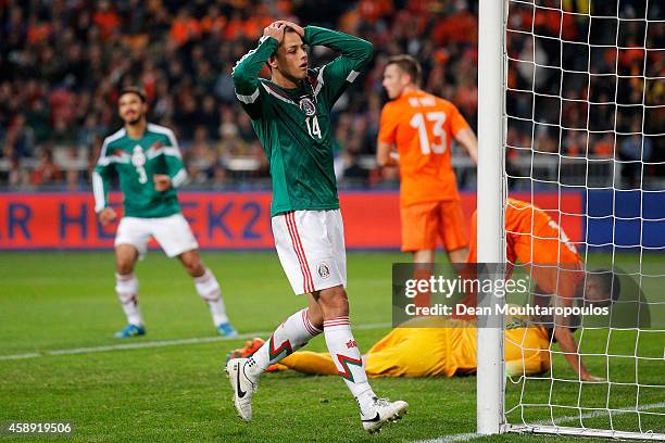 Javier Hernandez of Mexico holds his head after a missed chance on goal during the international friendly match between Netherlands and Mexico held...